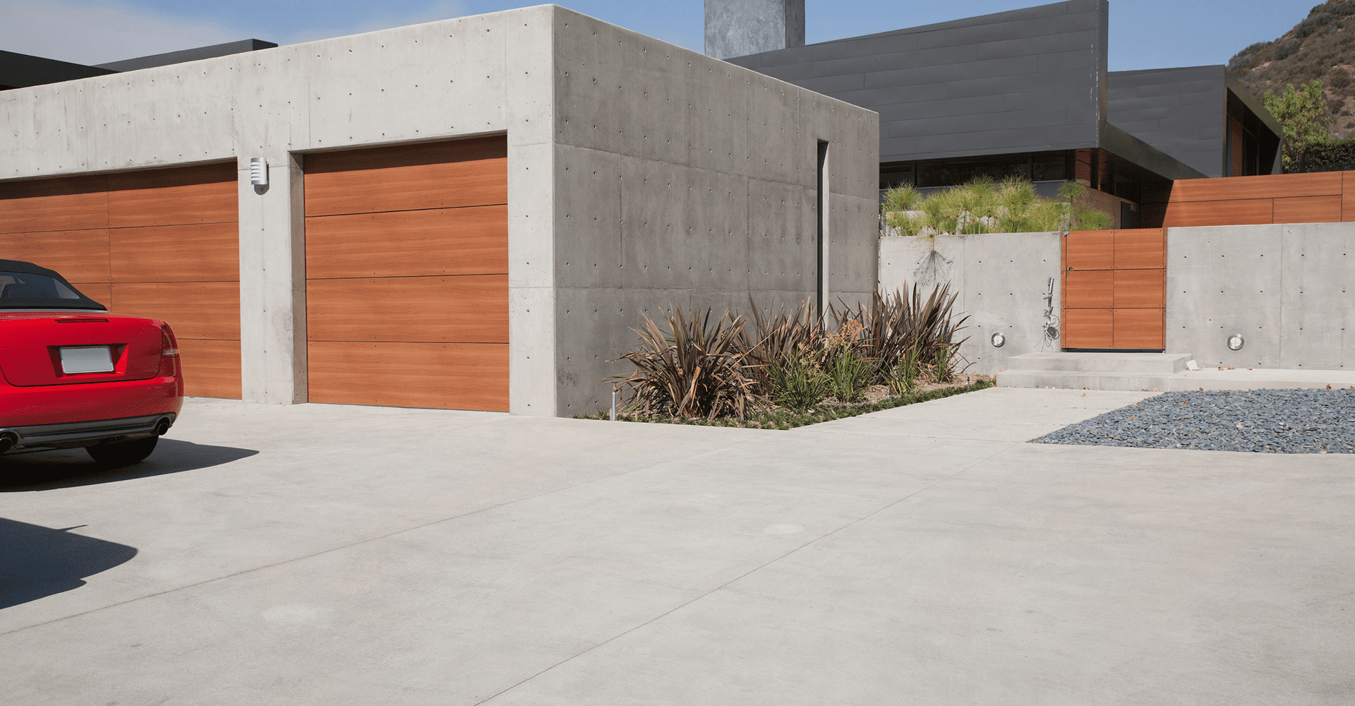 Modern house with wooden garage doors.