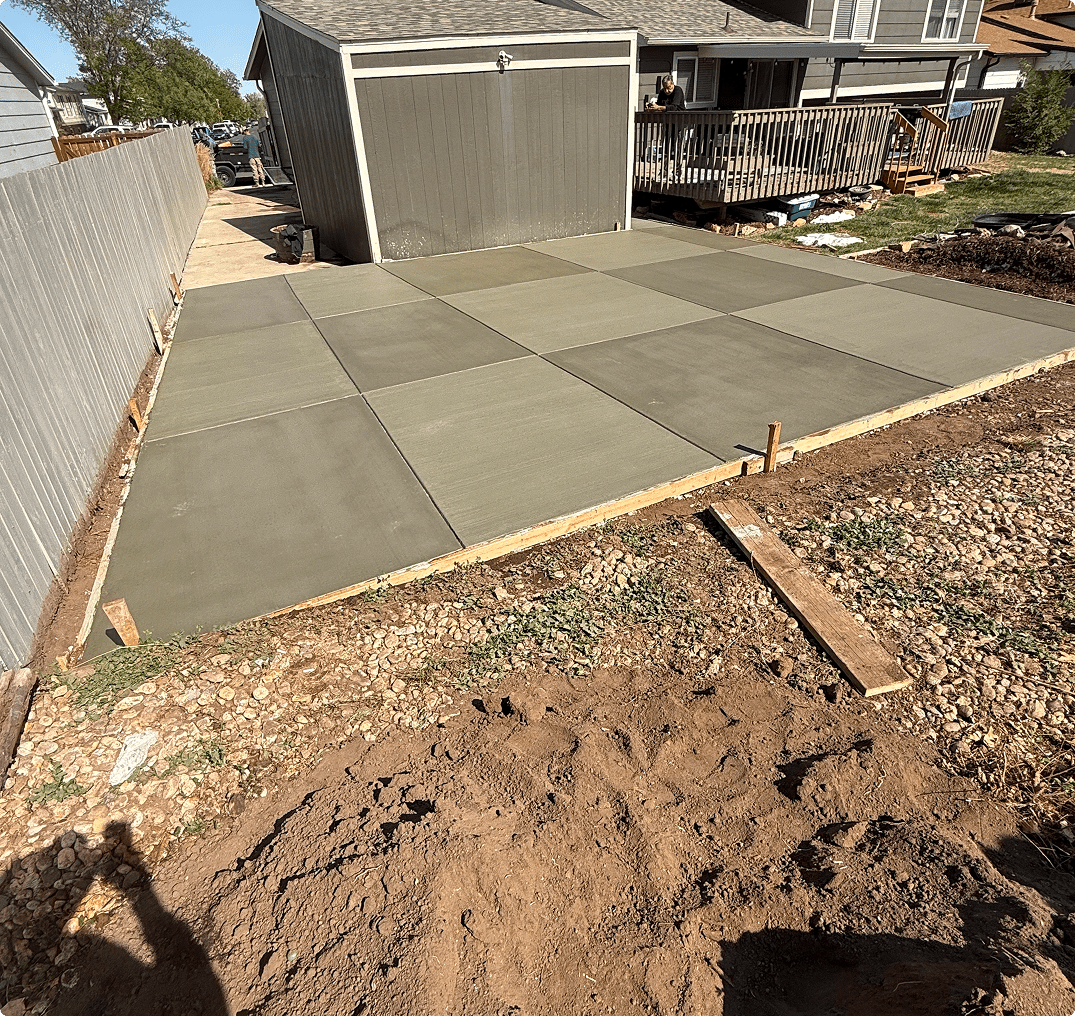 Freshly poured concrete driveway near garage Freshly poured concrete driveway near garage