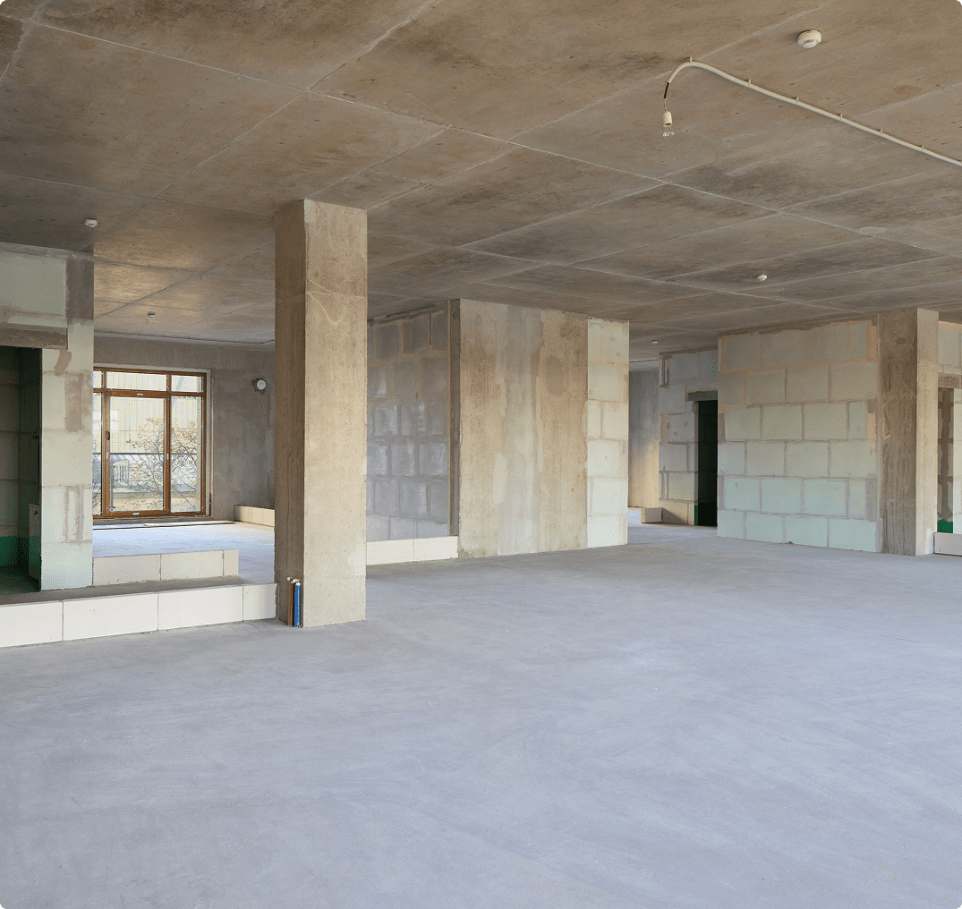 Spacious unfinished interior with concrete pillars Spacious unfinished interior with concrete pillars
